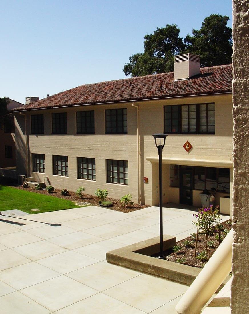 Exterior view of Clark Kerr Campus building on U.C.Berkeley, surrounded by landscaping and trees