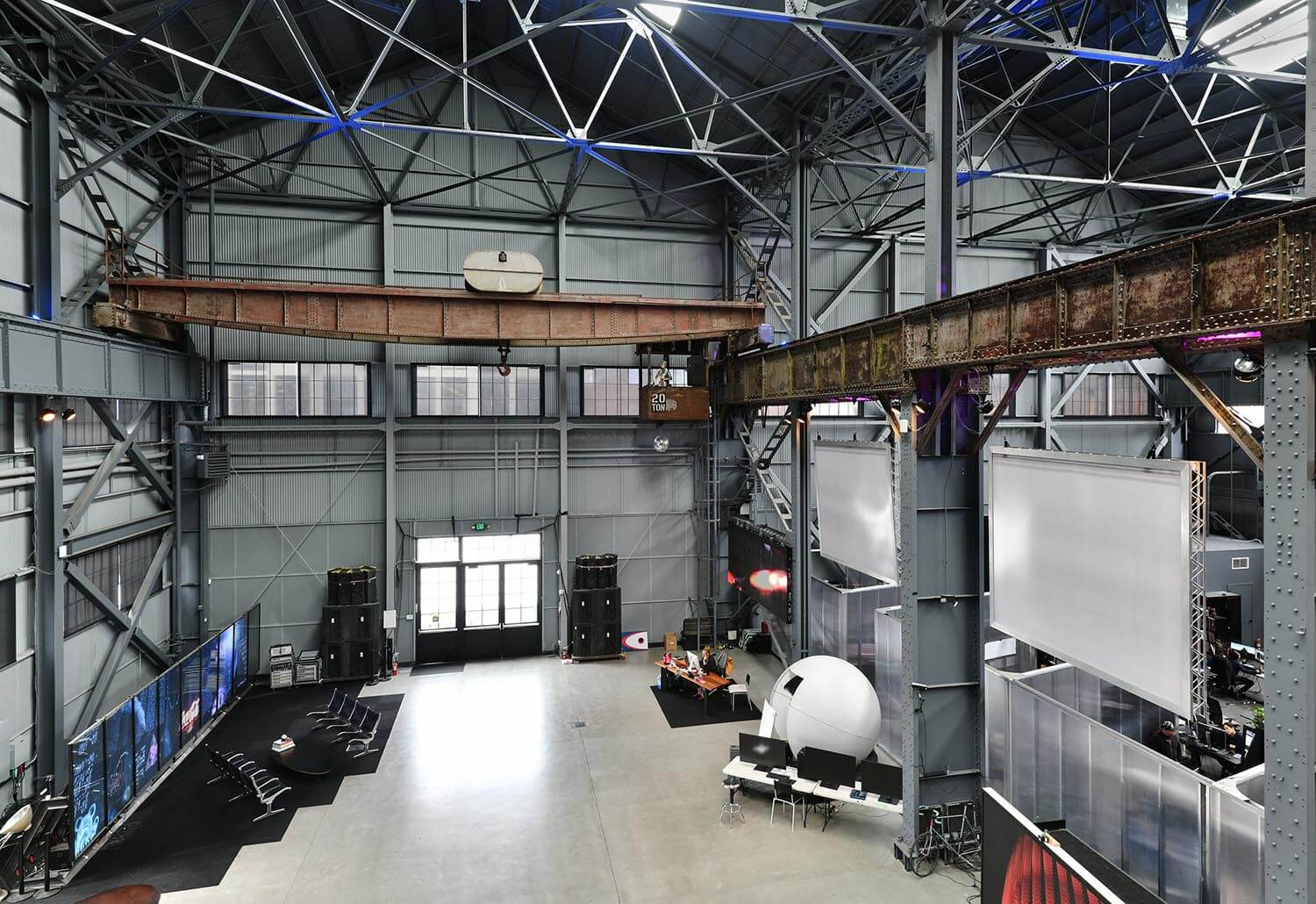 Interior view of spacious, open room at at Pier 70, Building 14 in San Francisco with metal walls and massive overhead crane