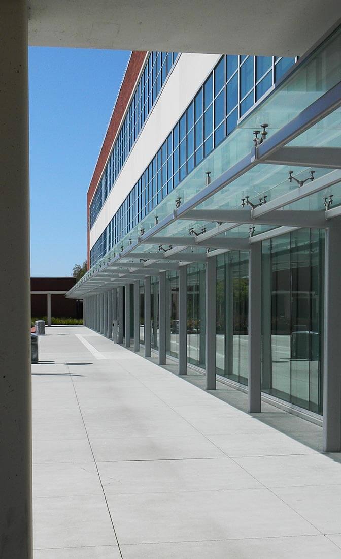 Exterior view of Richmond Civic Center in Richmond, CA showing brick and glass facade with covered walkway and adjacent courtyard